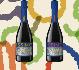 Two bottles of ISSIMO wine from Storica Wines feature colorful abstract labels and blue foil, set against a wavy, multicolored background.